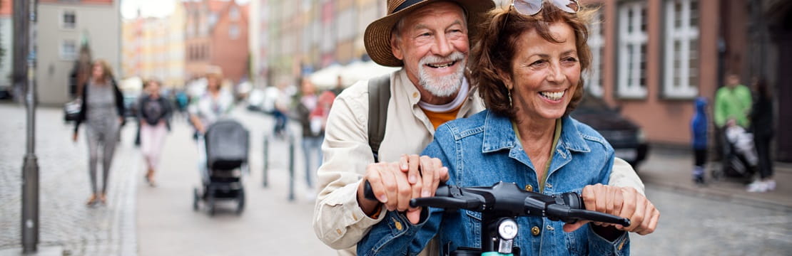 Overview Metadata Similar Portrait of happy senior couple tourists riding scooter together outdoors in town